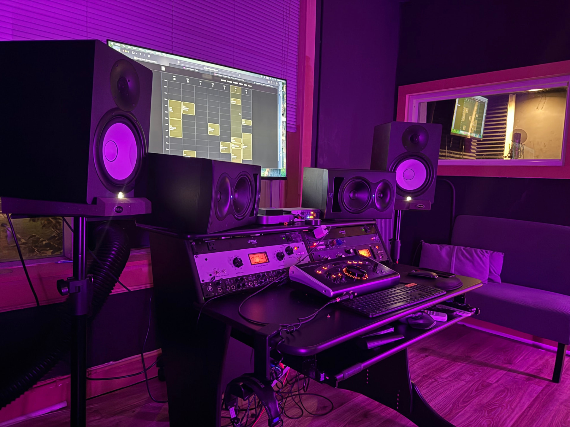 Studio wide shot with control desk and vocal booth window