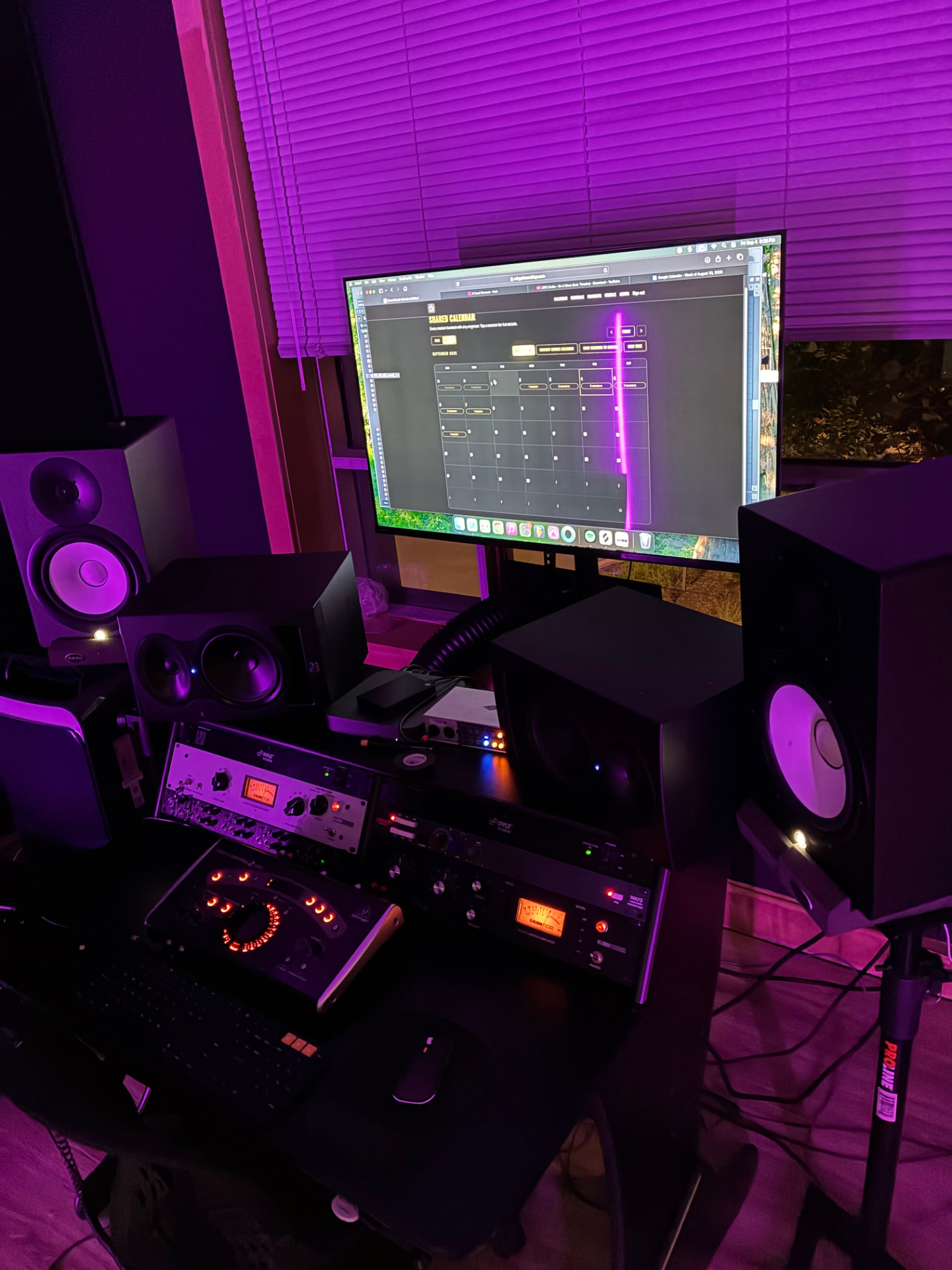 Studio control room with speakers and mixing desk